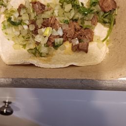 a flatbread with meat and vegetables a flatbread with meat and vegetables