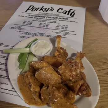 Porky's Cafe - a plate of chicken wings and a side of cucumbers - American Near Me - Shelton, Connecticut