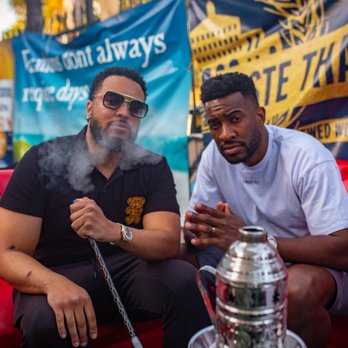 Elevations Hookah - two men smoking a hookah - Caterers Near Me