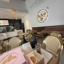 Honey Cup Coffeehouse & Creamery - Ambiance of wagonwheel cafe interior with coco pebbles latte and many pastries