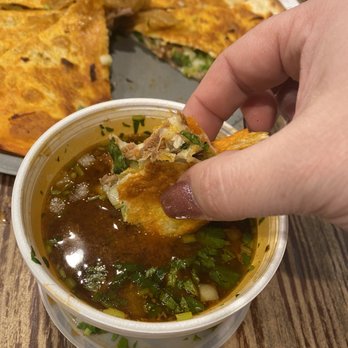 Tacoz California - Dipping the Pizzadilla in the birria consomé - Mexican Near Me - Cedar Falls, Iowa