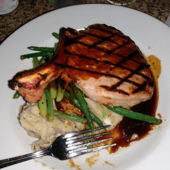 The Mansion - pork chop with garlic mashed potatoes, Gravy and green beans. - New American Near Me - Melbourne, Florida