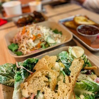 Barnyard Chicken - GREEN CAESAR SALAD Oven dried tomatoes, cucumber, marinated onions, sourdough croutons & parmesan - Chicken Shop Near Me - North Charleston, South Carolina