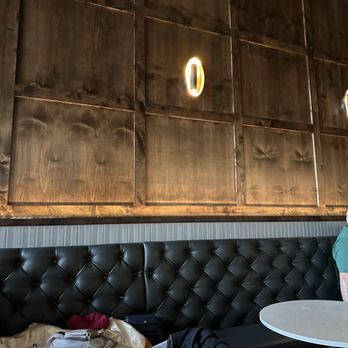 Ruin - a woman sitting at a table in a restaurant - Lounges Near Me - Salt Lake City, Utah
