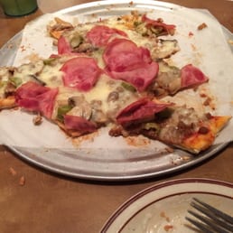 This is a Quatro special made of beef, mushroom, green olives, and Canadian bacon. A medium and it was too big for us to finish! This is a Quatro special made of beef, mushroom, green olives, and Canadian bacon. A medium and it was too big for us to finish!