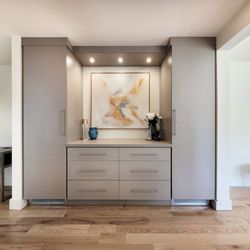 Rylex Custom Cabinetry & Closets - Flanked by sleek wardrobe towers and anchored by wide, soft-close drawers, the cabinetry adds storage and function.
