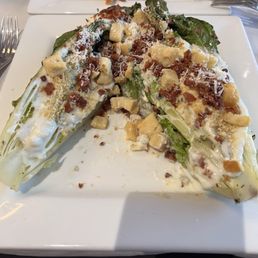 Warm romaine hearts topped with croutons, shaved Parmesan, bacon crumbled and creamy blue cheese dressing! Warm romaine hearts topped with croutons, shaved Parmesan, bacon crumbled and creamy blue cheese dressing!