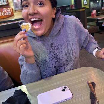 Razzoo's Cajun Cafe - Karla is enjoying a ranch dipped fried pickle. - Cajun/Creole Near Me - College Station, Texas