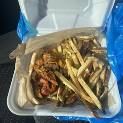 Kielbasa sandwich with sautéed peppers, onions and sauerkraut with fresh cut fries.