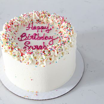 Calculated Confections - Gluten-free cake with whipped topping, full view - A birthday cake with white frosting, decorated with piped frosting and multicolored sprinkles, featuring a message in pink icing. - Patisserie/Cake Shop Near Me - Walden, New York
