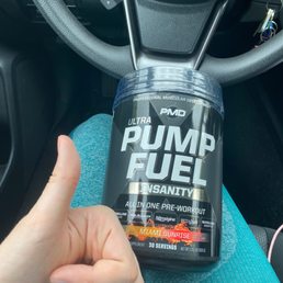 a hand holding a bottle of pump fuel