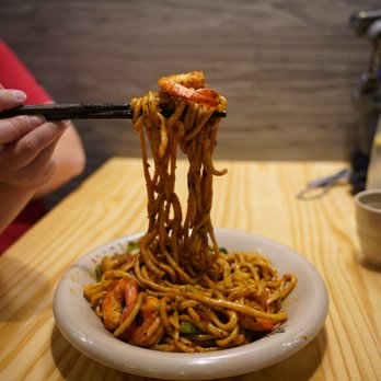 Mogouyan Hand-Pulled Noodles - a person eating - Noodles Near Me - Toronto, Ontario