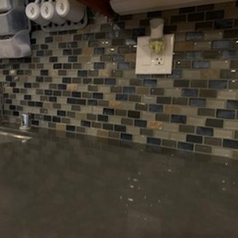 Nightingale Apartments - The kitchen counter top with the stone and glass backsplash. - Apartments Near Me - San Diego, California