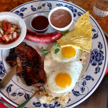 Uncle Mike's Place - Longanisa and skirt steak combo with sunny side up eggs, cilantro, a1 sauce, side of pico de gallo and champorado - Breakfast & Brunch Near Me - Chicago, Illinois Uncle Mike's Place - Longanisa and skirt steak combo with sunny side up eggs, cilantro, a1 sauce, side of pico de gallo and champorado - Breakfast & Brunch Near Me - Chicago, Illinois