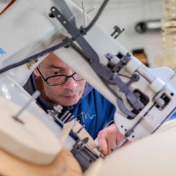 An Oklahoma Mattress Company craftsman lock stitches a seam on an innerspring mattress.