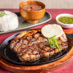 Inca Paisa restaurant Astoria - Grilled Punta de Anca steak served with traditional Latin sides at Inca Paisa Astoria, combining premium cuts with Colombian-...
