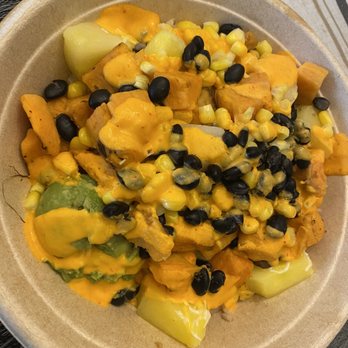 Grabbagreen - Southwest bowl - A bowl containing chunks of vegetables like squash and potatoes, topped with melted cheese and black beans, served in a disposable container. - Juice Bars & Smoothies Near Me - Killeen, Texas