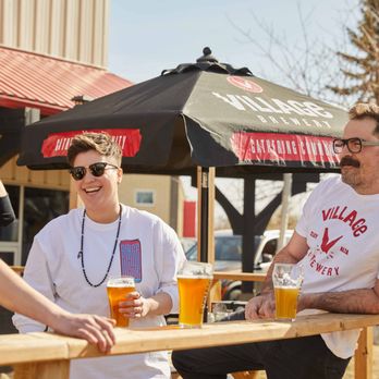 Village Brewery - three men sitting at a table with beers - Breweries Near Me - Calgary, Alberta Village Brewery - three men sitting at a table with beers - Breweries Near Me - Calgary, Alberta