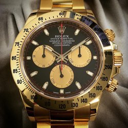 Finley's Jewelers - Solid 18 karat yellow gold 2016 Rolex Daytona with the special black and red Paul Newman dial