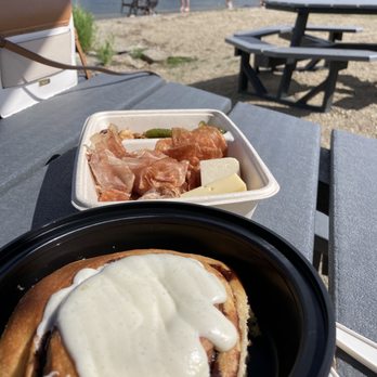 Frind Estate Winery - Enjoying our Cinnamon bun and charcuterie set after our wine tasting. There's picnic tables right outside of the winery on the beach front! - Wineries Near Me - West Kelowna, British Columbia