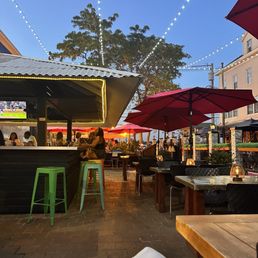 a patio with tables and umbrellas