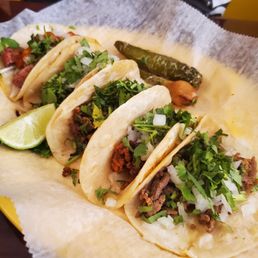 three tacos on a plate three tacos on a plate