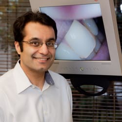 New Wave Dental Smiles - Dr. Bajwa smiling big for the camera.