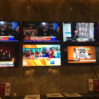Turkish Airlines - Inside the Turkish Airlines Lounge. Granite walls lined with televisions. - Airlines Near Me - Dulles, Virginia