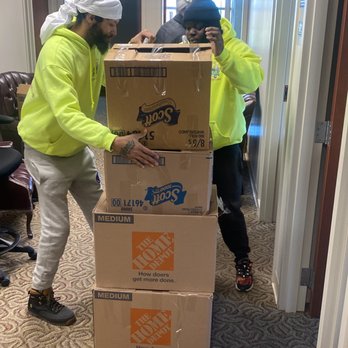 Roger & Sons - two men moving boxes in an office - Junk Removal & Hauling Near Me Roger & Sons - two men moving boxes in an office - Junk Removal & Hauling Near Me
