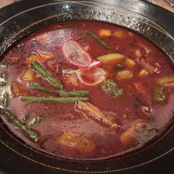Hugo's - MOLE DE OLLA hearty oxtail soup, vegetables, onion, fresh cilantro - Mexican Near Me - Houston, Texas