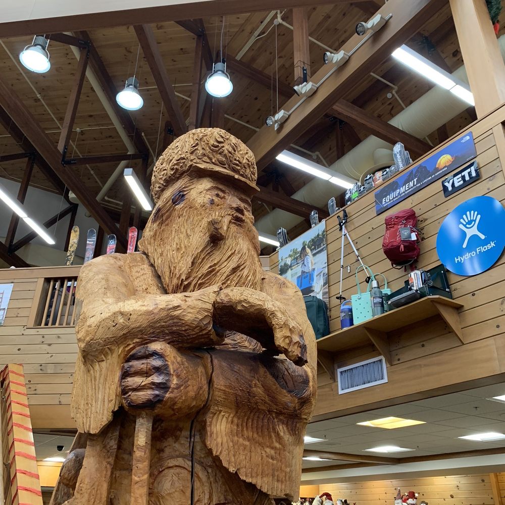 Kittery Trading Post - Wood-carved man guarding the main entrance to Kittery Trading Post - Hunting & Fishing Supplies Near Me - Kittery, Maine Kittery Trading Post - Wood-carved man guarding the main entrance to Kittery Trading Post - Hunting & Fishing Supplies Near Me - Kittery, Maine