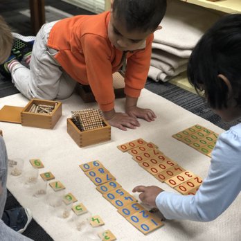 International Montessori - Math work being observed by a younger student in the mixed age environment - Montessori Schools Near Me - Austin, Texas International Montessori - Math work being observed by a younger student in the mixed age environment - Montessori Schools Near Me - Austin, Texas