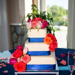 Wedding cake accented with lush roses.