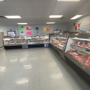 Penshorns Meat Market - a man standing in front of a display of meat - Meat Shops Near Me - Marion, Texas Penshorns Meat Market - a man standing in front of a display of meat - Meat Shops Near Me - Marion, Texas