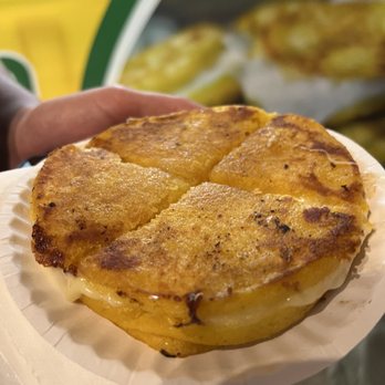 Gran Arepa - a person holding a plate of food - Food Delivery Services Near Me