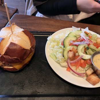 Maggie McFly's - Pulled pork on a pretzel roll with a side salad. The dressing was spoiled. - New American Near Me - Glastonbury, Connecticut Maggie McFly's - Pulled pork on a pretzel roll with a side salad. The dressing was spoiled. - New American Near Me - Glastonbury, Connecticut