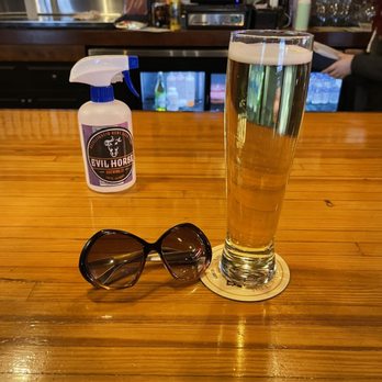 Evil Horse Brewing Company - a glass of beer and sunglasses - Breweries Near Me - Crete, Illinois Evil Horse Brewing Company - a glass of beer and sunglasses - Breweries Near Me - Crete, Illinois