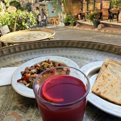 Tomtom Kebap - Turşu Suyu -Turkish Pickle Juice and the complementary tomato salad and delicious bread that the restaurant offers.