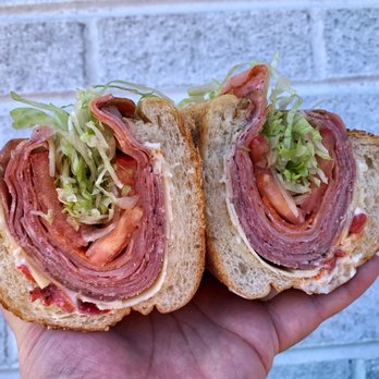 Marinucci's Deli - Mayfair - a hand holding a sandwich - Delis Near Me - Philadelphia, Pennsylvania Marinucci's Deli - Mayfair - a hand holding a sandwich - Delis Near Me - Philadelphia, Pennsylvania