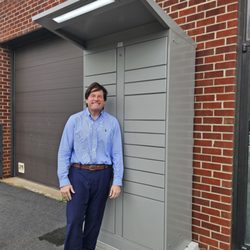 Minuteman Press - Jim in front of the office, showing off print pick up kiosk.