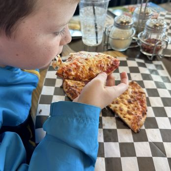 The Pizza Press - Kid enjoying his pizza - Pizza Near Me - Winter Garden, Florida The Pizza Press - Kid enjoying his pizza - Pizza Near Me - Winter Garden, Florida