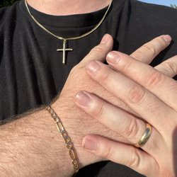 Rowland Heights Jewelry Mart - Gold wedding band, cross, and bracelet.
