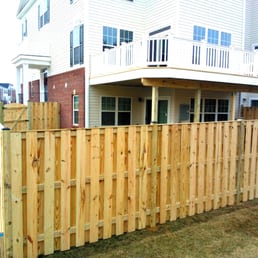 Elevated deck and 6ft alternating board style custom built fence by Alger Deck & Fence