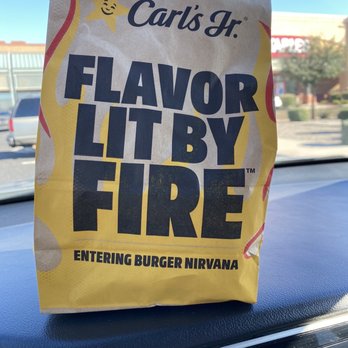 Carl's Jr. - a paper bag on the hood of a car - Burgers Near Me - Mesa, Arizona