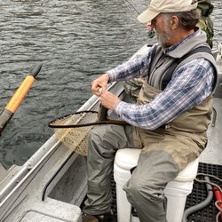 Ozark Angler - Guide George unhooking the trout.
