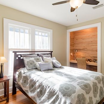CenterBeam Construction - Remodeled Bungalow: Master bedroom: original wood floors and windows. Room also has a built in office work-space with a wood paneled wall. - General Contractors Near Me - Jacksonville, Florida