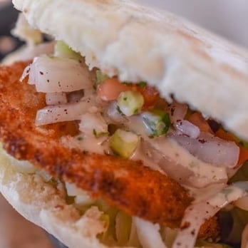 Falafel Mediterranean Cusine - Shnitzel - pita bread filled with hummus, fried breaded chicken Brest and tehine. - Mediterranean Near Me - Ensenada, BCN Falafel Mediterranean Cusine - Shnitzel - pita bread filled with hummus, fried breaded chicken Brest and tehine. - Mediterranean Near Me - Ensenada, BCN