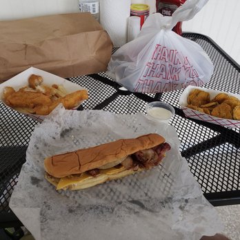 Cravin Cajun - a sandwich and fries on a table - Cajun/Creole Near Me - Rosepine, Louisiana Cravin Cajun - a sandwich and fries on a table - Cajun/Creole Near Me - Rosepine, Louisiana