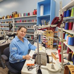 Orlan's Tailoring - My wife working at our former Chelsea location, where we proudly served the community with tailoring and alteration services.