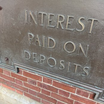 BlackCraft Cult - A metal plaque mounted on a brick wall displays the words "Interest Paid on Deposits," indicating a financial or banking context. - Men's Clothing Near Me - Salem, Massachusetts